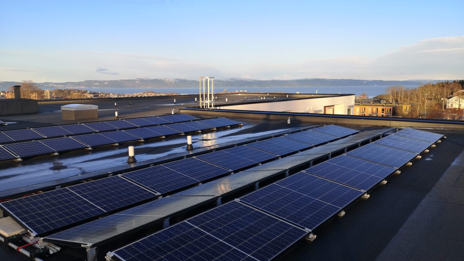 View across the roof of a large building fitted with solar panels.